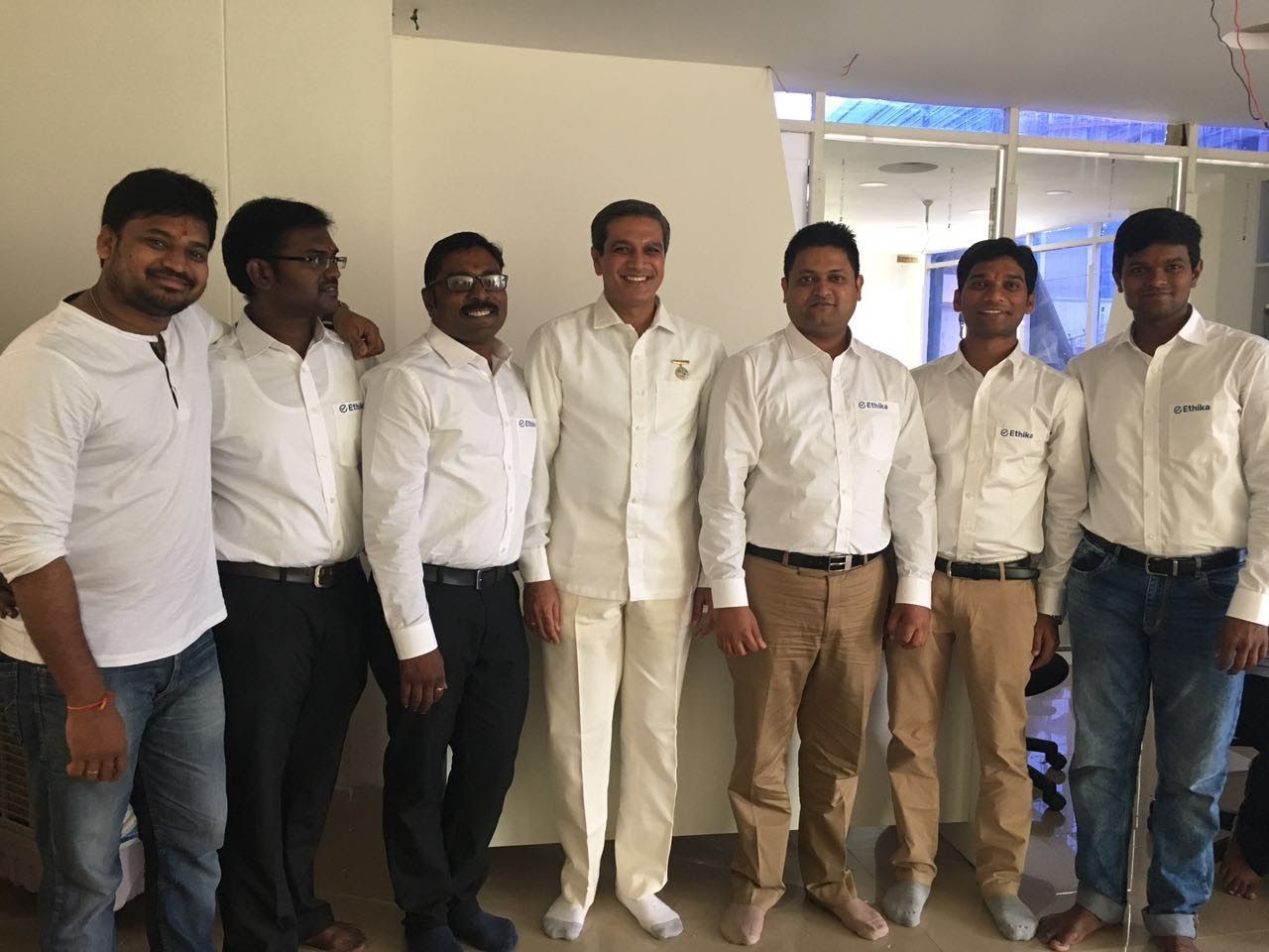 The Ethika team in white with a guide at an early wellness session