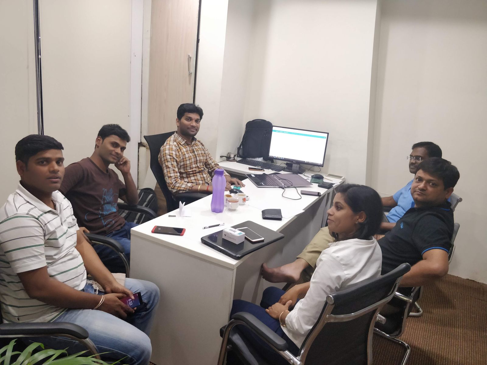 The team in the office with an early version of the Ethika platform on screen